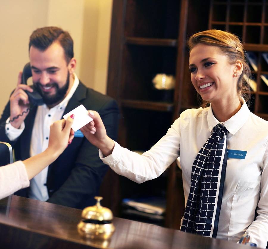 Picture of guests getting key card in hotel